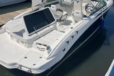 The Image of 2015 Chaparral 21 H2O Sport boat docked, featuring sleek design and spacious seating. - 1