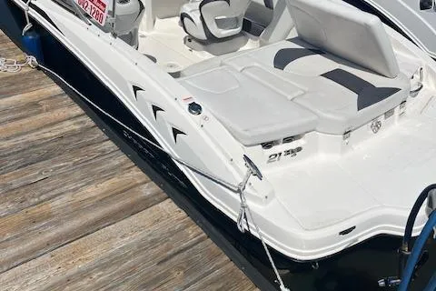 Slide: The Image of 2015 Chaparral 21 H2O Sport boat docked, featuring sleek white design and comfortable seating. - 3
