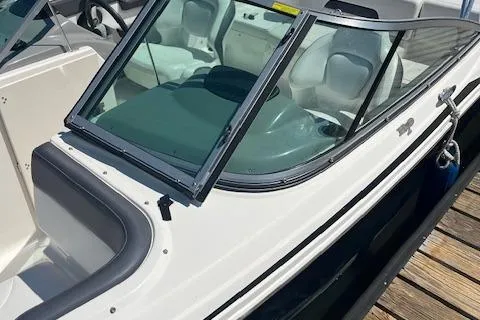 Slide: The Image of 2015 Chaparral 21 H2O Sport boat docked, featuring sleek design and spacious seating. - 8