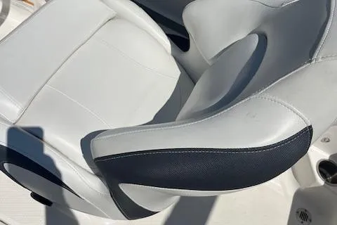 Slide: The Image of 2015 Chaparral 21 H2O Sport boat seat with white and black upholstery. - 9