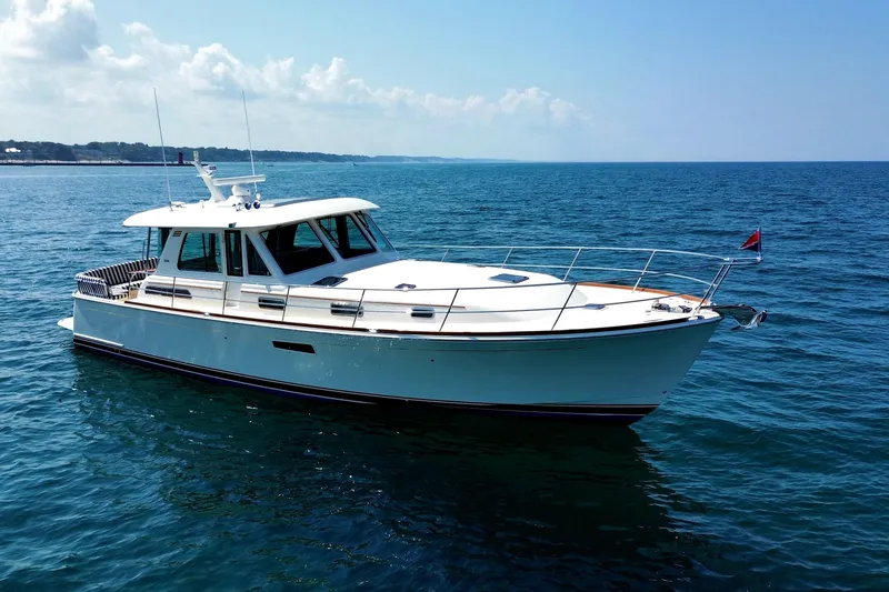 Slide: The Image of 2022 Sabre 48 Salon Express yacht cruising on open water under clear skies. - 1