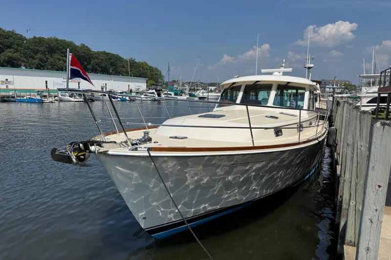 Slide: The Image of 2022 Sabre 48 Salon Express yacht docked at marina under clear sky. - 10