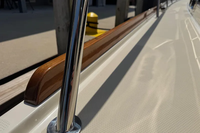 Slide: The Image of 2022 Sabre 48 Salon Express yacht deck with polished railing and wooden trim. - 15