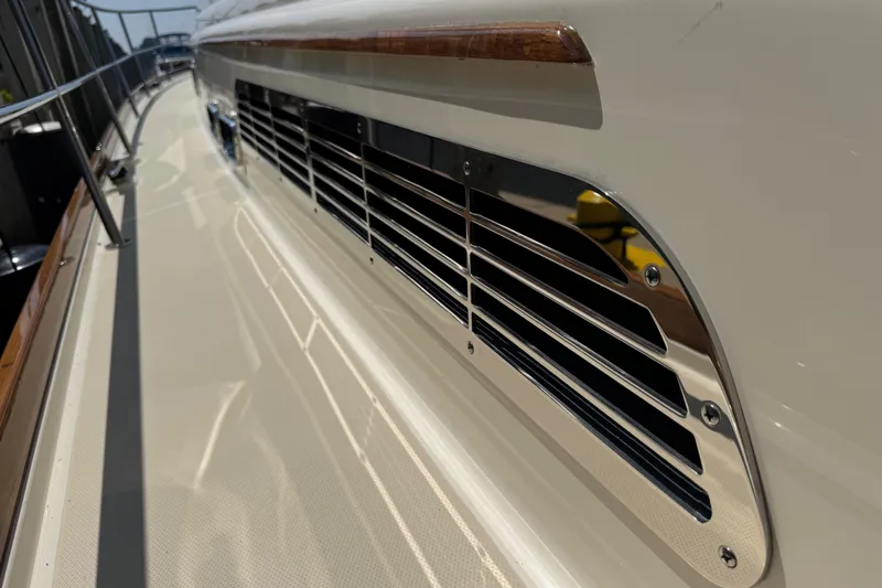 Slide: The Image of 2022 Sabre 48 Salon Express yacht, side view with sleek metal vent detail. - 16