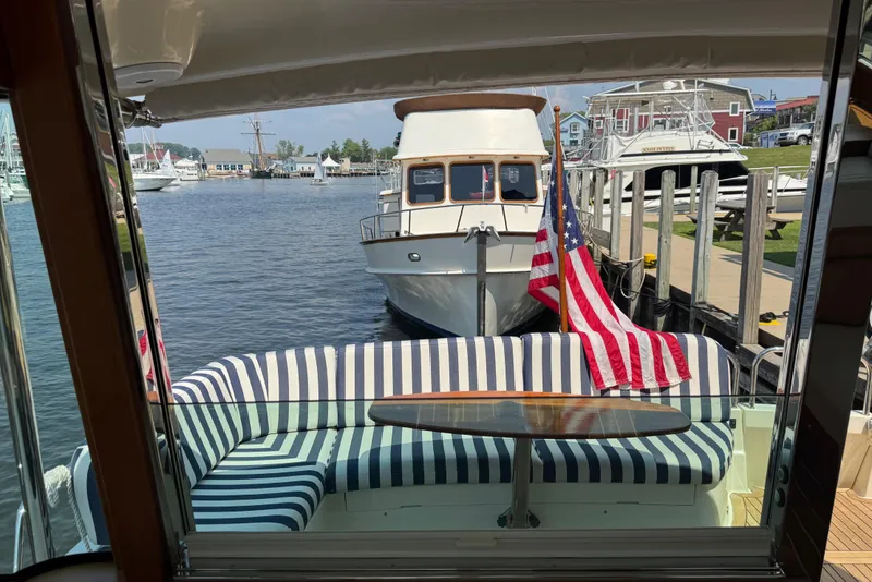 Slide: The Image of 2022 Sabre 48 Salon Express yacht interior with striped seating and American flag. - 27
