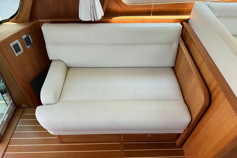 Slide: The Image of Luxurious white seating in 2022 Sabre 48 Salon Express yacht interior. - 28