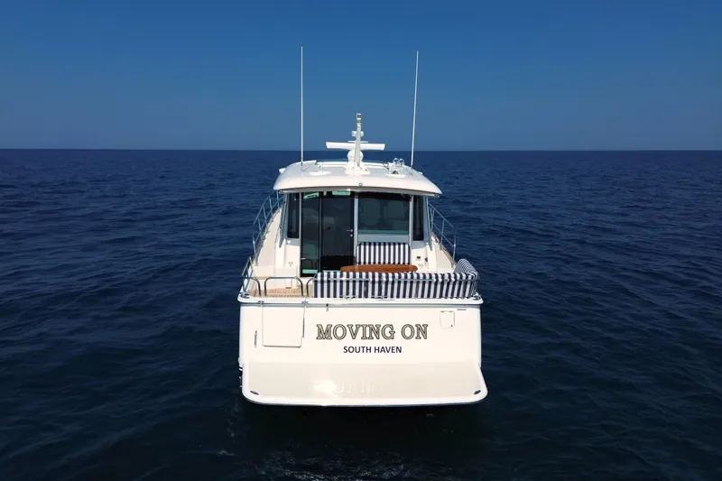 Slide: The Image of 2022 Sabre 48 Salon Express yacht "Moving On" on open sea, rear view. - 3