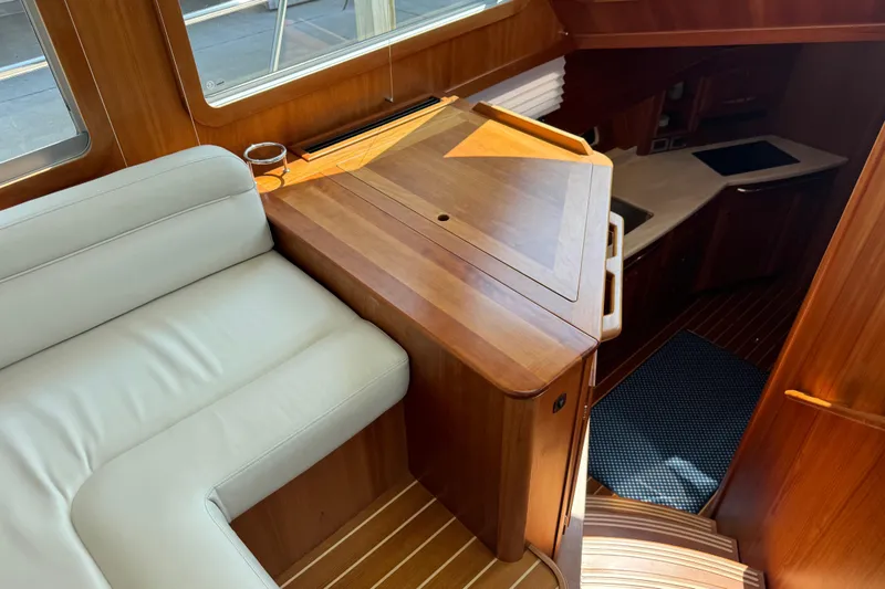 Slide: The Image of Interior of 2022 Sabre 48 Salon Express yacht with wooden cabinetry and white seating. - 31