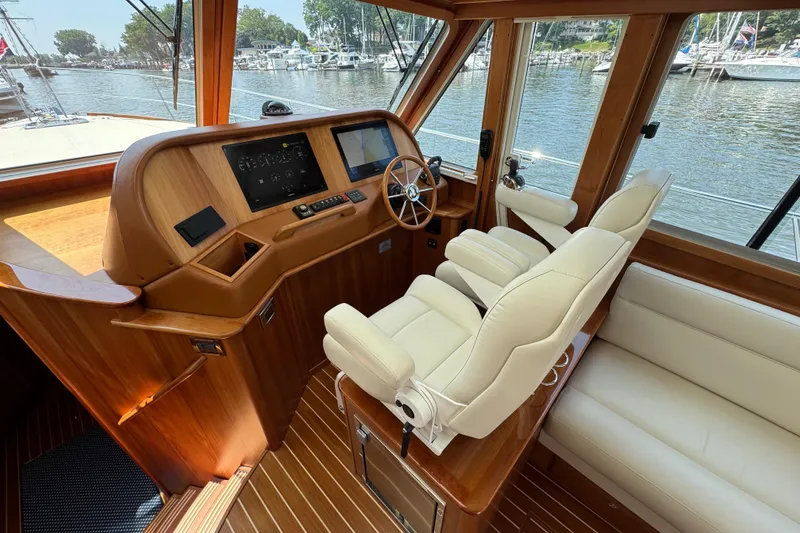 Slide: The Image of 2022 Sabre 48 Salon Express helm with luxurious seating and modern navigation controls. - 34