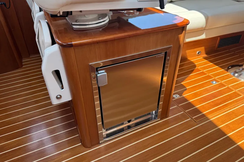 Slide: The Image of Luxurious interior of 2022 Sabre 48 Salon Express with wood finish and built-in fridge. - 36