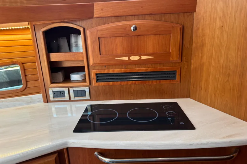 Slide: The Image of Modern kitchen interior of 2022 Sabre 48 Salon Express yacht with electric cooktop. - 46