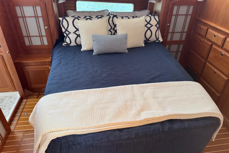 Slide: The Image of Luxurious bedroom interior of 2022 Sabre 48 Salon Express yacht with elegant bedding. - 48