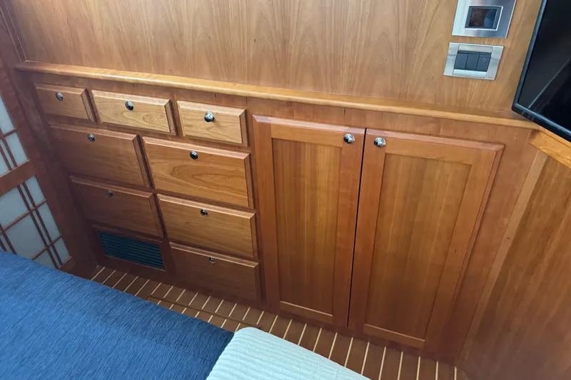 Slide: The Image of Wooden cabinetry in 2022 Sabre 48 Salon Express yacht interior, featuring drawers and paneling. - 49