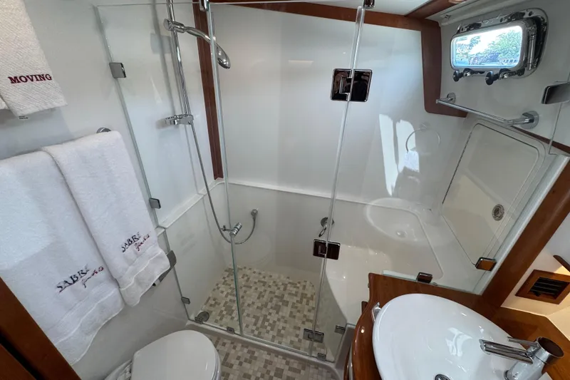 Slide: The Image of Luxurious bathroom in 2022 Sabre 48 Salon Express yacht with glass shower and elegant fixtures. - 52