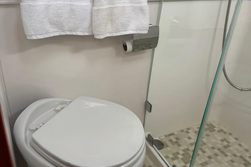 Slide: The Image of Bathroom interior of 2022 Sabre 48 Salon Express yacht, featuring toilet and shower. - 53