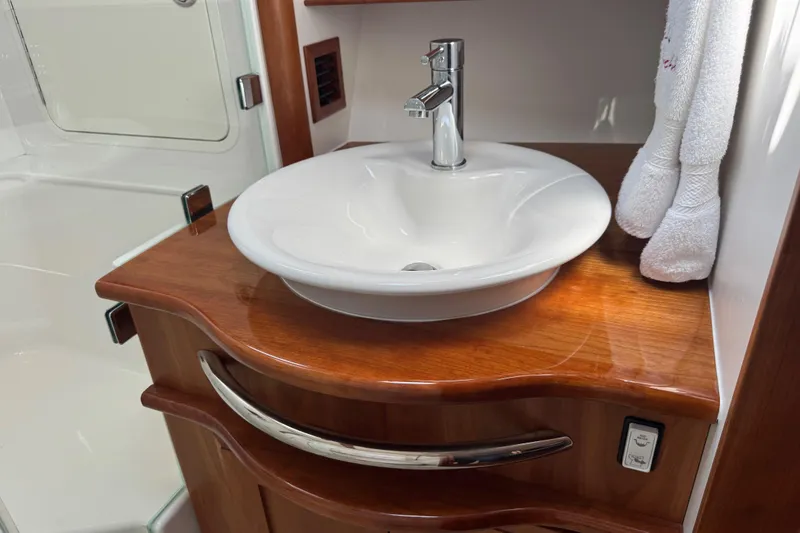 Slide: The Image of Luxurious bathroom sink in 2022 Sabre 48 Salon Express yacht, featuring elegant wood finish. - 54