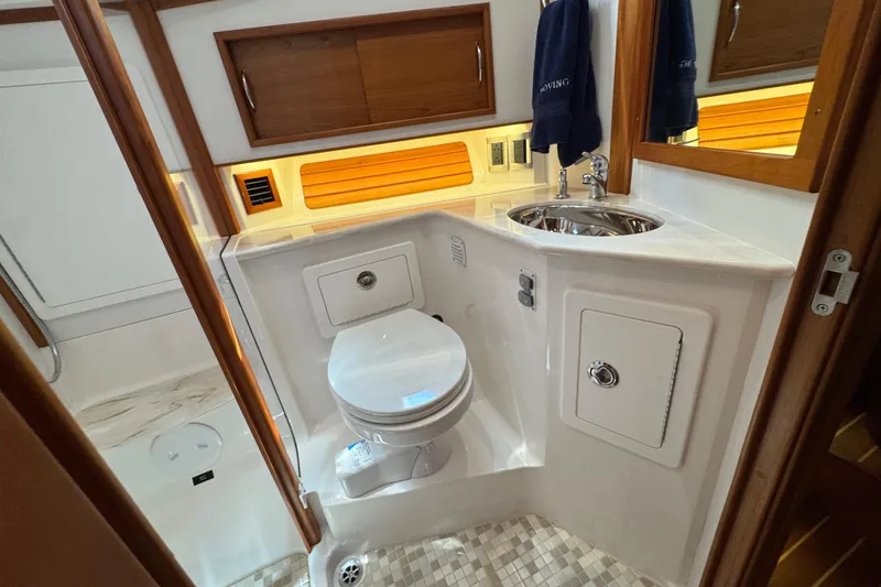 Slide: The Image of 2022 Sabre 48 Salon Express bathroom with modern fixtures and wood accents. - 56