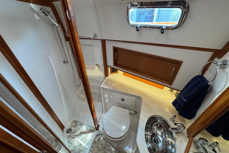 Slide: The Image of Luxurious bathroom in 2022 Sabre 48 Salon Express yacht with modern fixtures and wood accents. - 57