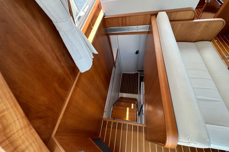 Slide: The Image of Interior view of 2022 Sabre 48 Salon Express, featuring wooden finishes and a staircase. - 59