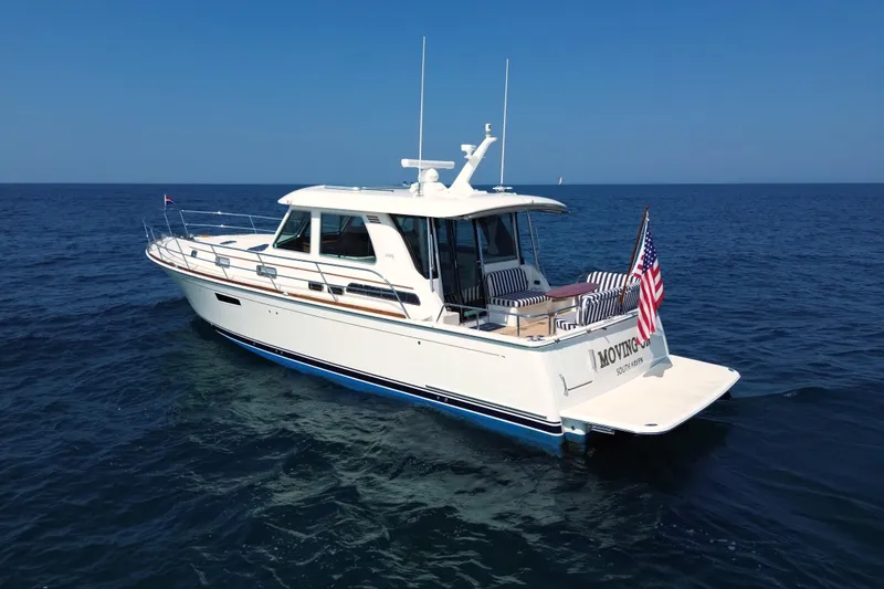 Slide: The Image of 2022 Sabre 48 Salon Express yacht on open sea, featuring sleek design and American flag. - 6