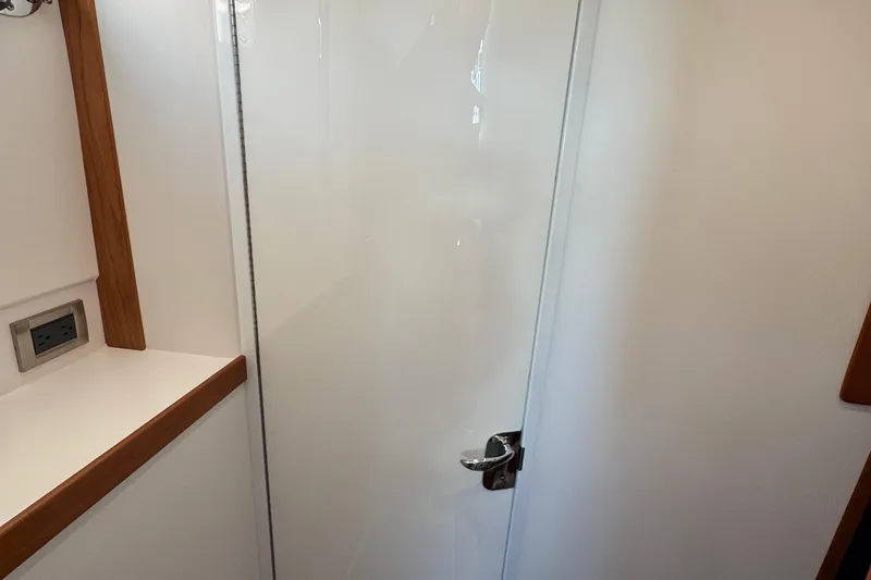 Slide: The Image of 2022 Sabre 48 Salon Express interior with sleek white door and wooden trim. - 60