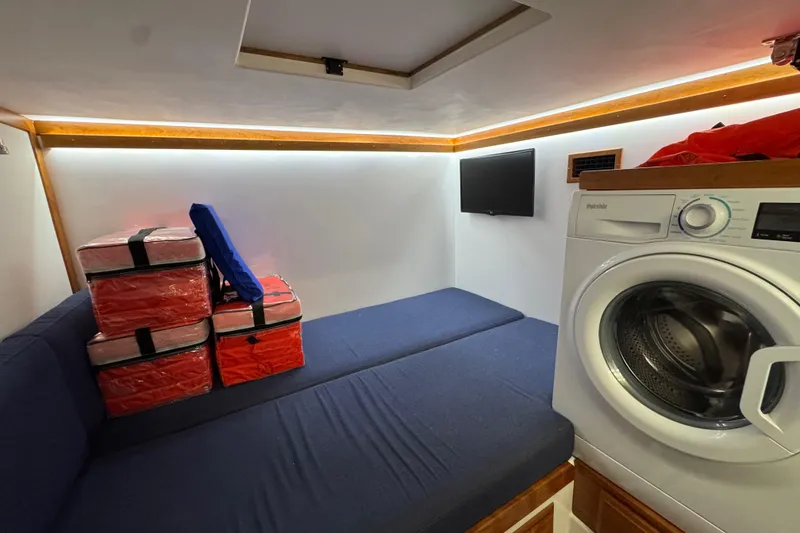 Slide: The Image of Interior of 2022 Sabre 48 Salon Express with seating, washer, and storage. - 65