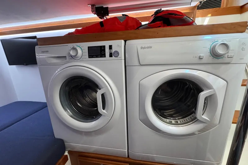 Slide: The Image of Laundry appliances inside 2022 Sabre 48 Salon Express yacht interior. - 66