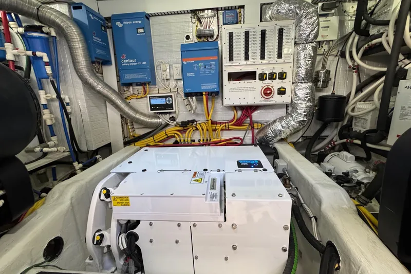 Slide: The Image of Engine room of 2022 Sabre 48 Salon Express with electrical systems and wiring. - 68