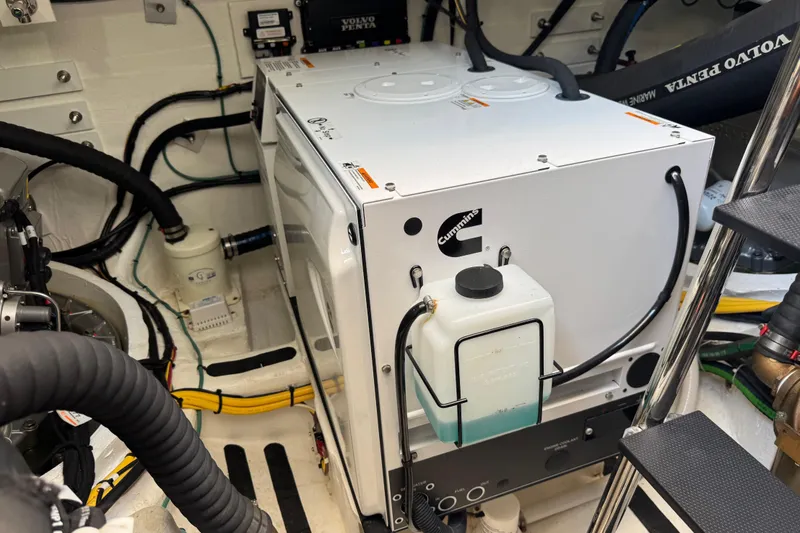 Slide: The Image of Engine room of 2022 Sabre 48 Salon Express with Cummins generator and Volvo Penta components. - 69