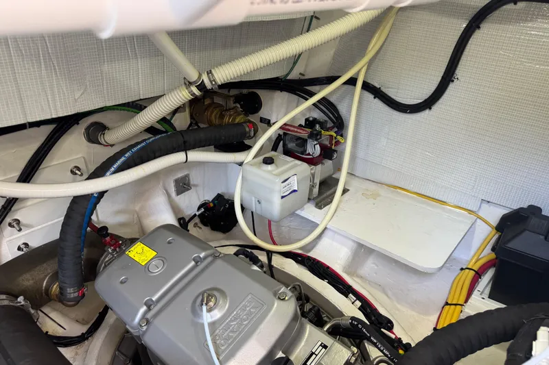 Slide: The Image of Engine room of 2022 Sabre 48 Salon Express with visible wiring and components. - 71