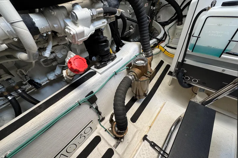 Slide: The Image of Engine room of 2022 Sabre 48 Salon Express, showcasing mechanical components and piping. - 77