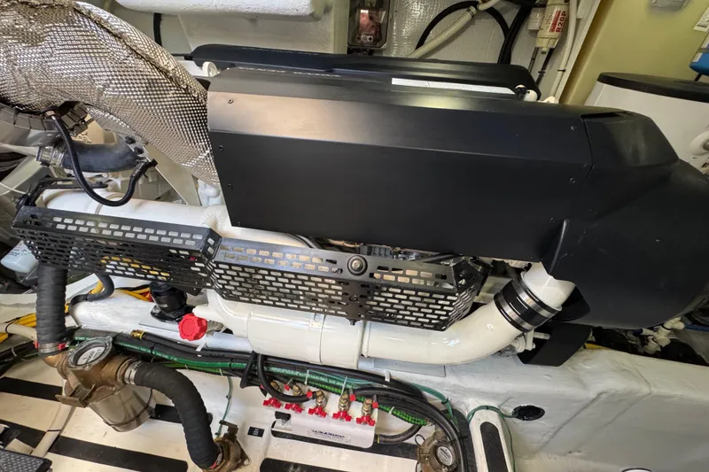 Slide: The Image of Engine room of 2022 Sabre 48 Salon Express yacht, showcasing mechanical components and piping. - 80