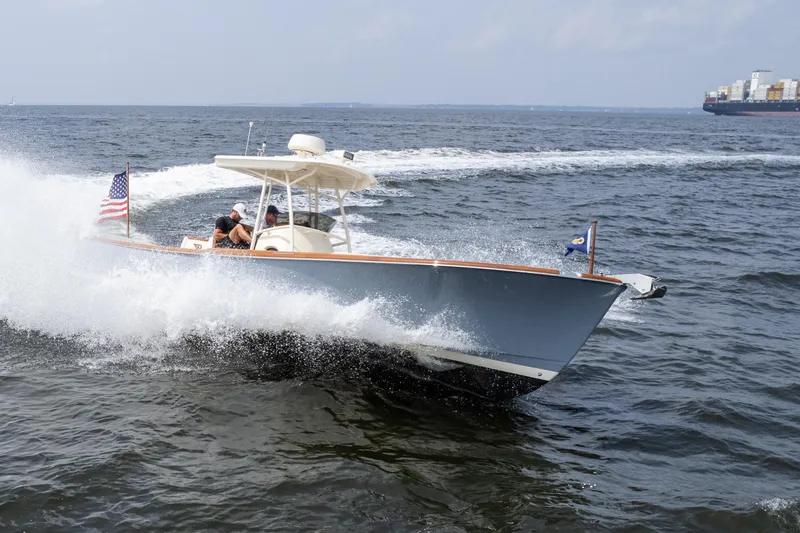 Slide: The Image of 2017 Hinckley Talaria 29C cruising on open water with American flag. - 11