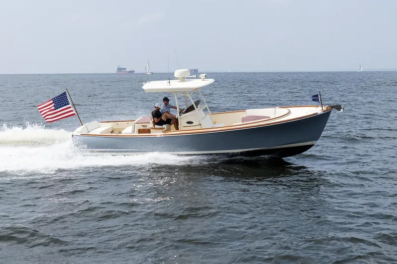 Slide: The Image of 2017 Hinckley Talaria 29C cruising on open water with American flag. - 12