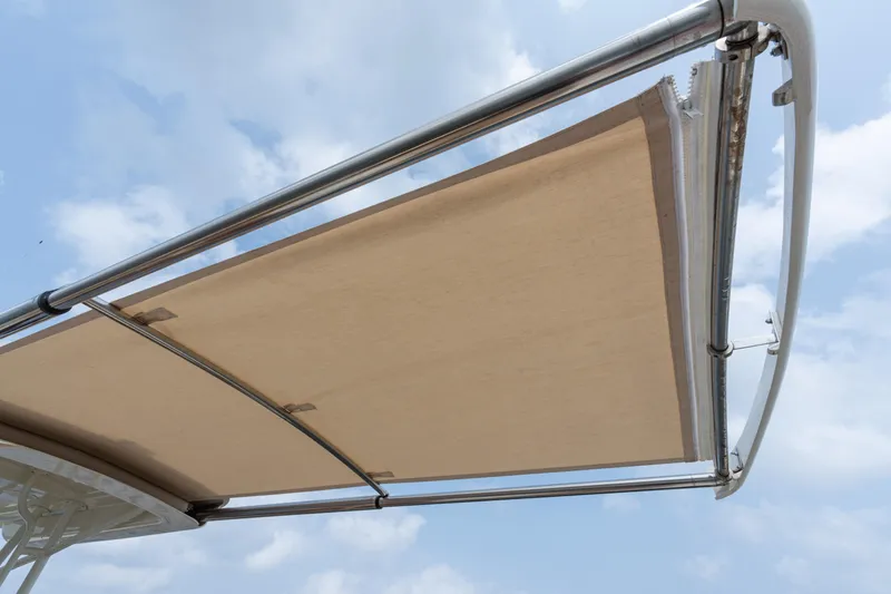 Slide: The Image of 2017 Hinckley Talaria 29C boat canopy against a cloudy sky. - 15