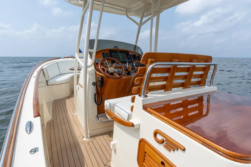 Slide: The Image of 2017 Hinckley Talaria 29C boat interior with polished wood and ocean view. - 20