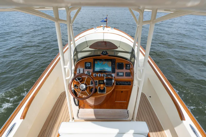 Slide: The Image of 2017 Hinckley Talaria 29C boat helm with wooden dashboard and navigation equipment. - 21