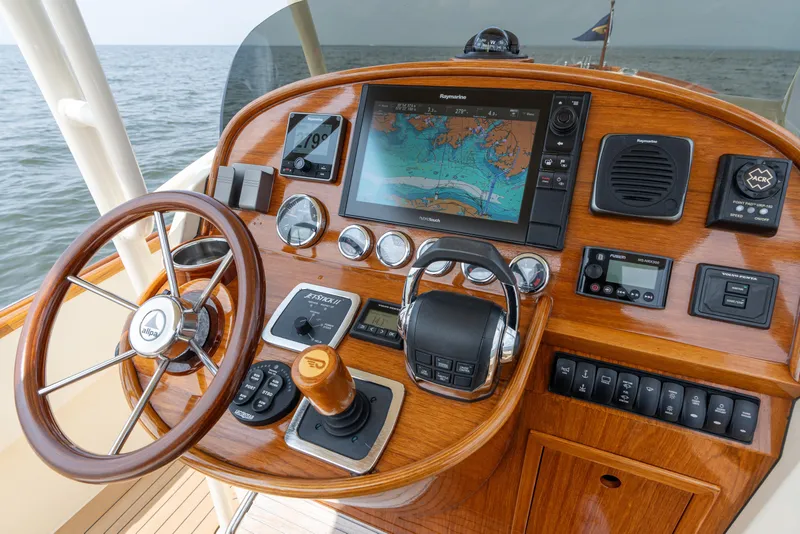 Slide: The Image of Helm of 2017 Hinckley Talaria 29C with navigation system and wooden steering wheel. - 22