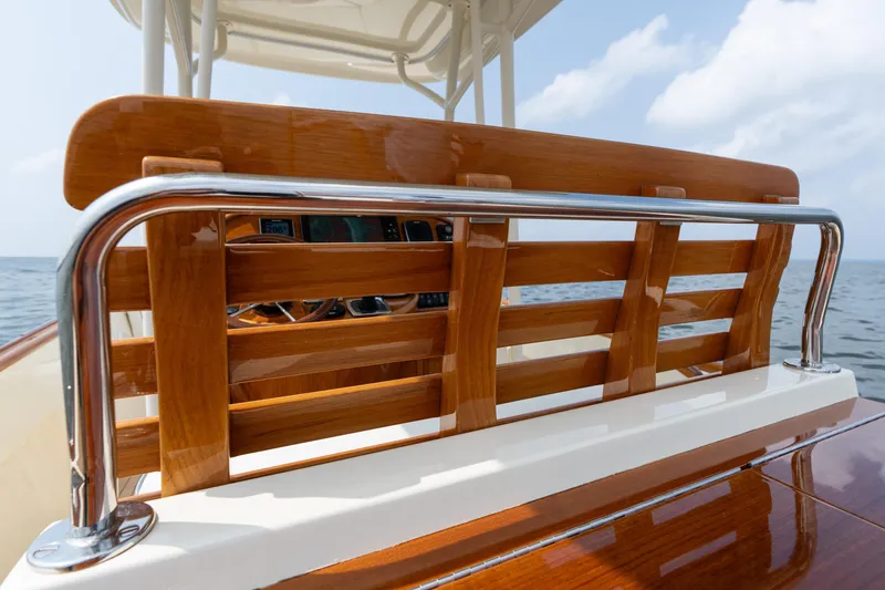 Slide: The Image of 2017 Hinckley Talaria 29C boat with polished wood and chrome details on open water. - 26