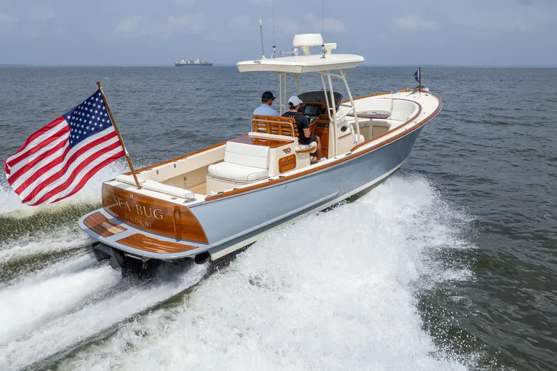 Slide: The Image of 2017 Hinckley Talaria 29C boat cruising with American flag on open water. - 34