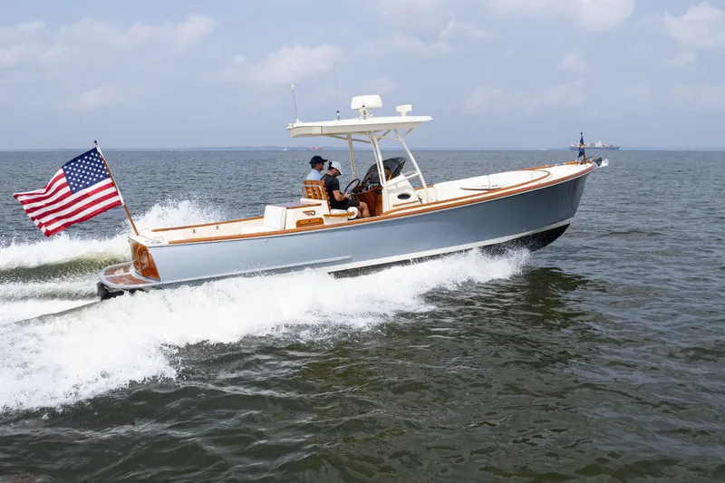 Slide: The Image of 2017 Hinckley Talaria 29C cruising on open water with American flag. - 4