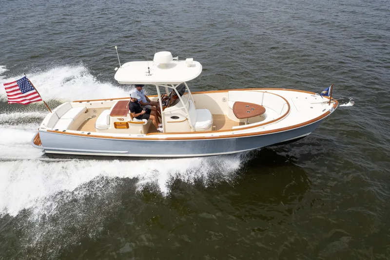Slide: The Image of 2017 Hinckley Talaria 29C cruising on open water with American flag. - 5