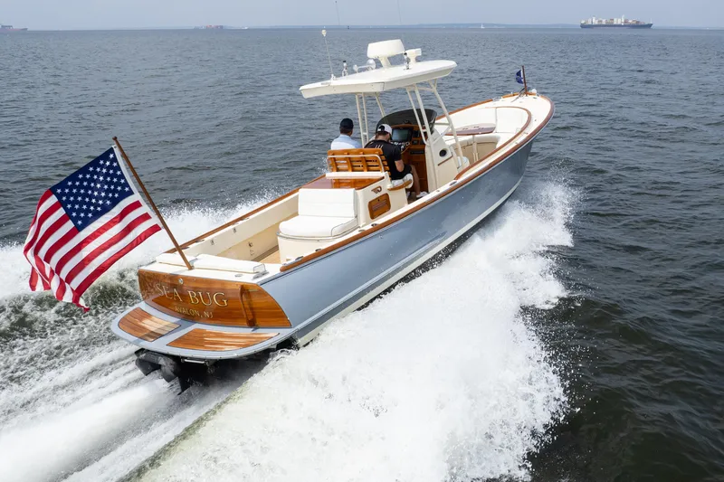 Slide: The Image of 2017 Hinckley Talaria 29C cruising with American flag on open water. - 7