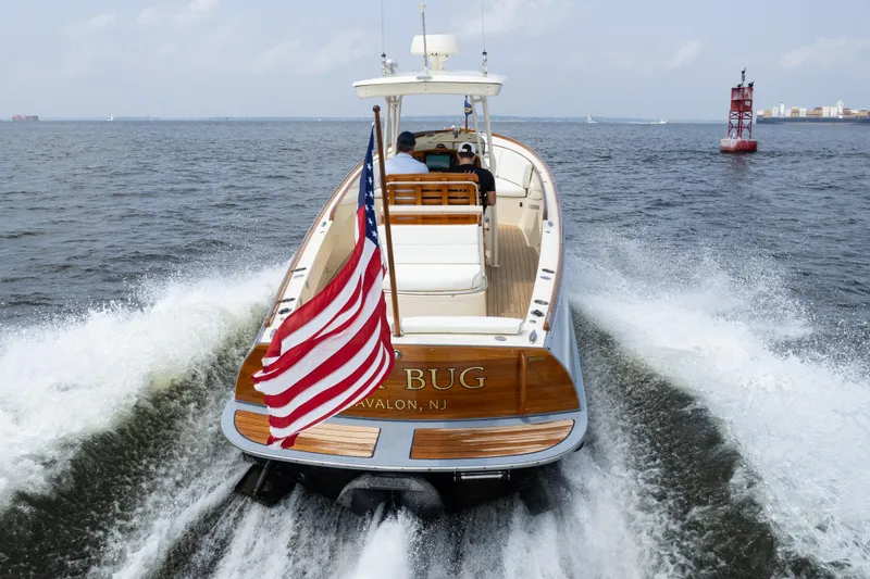 Slide: The Image of 2017 Hinckley Talaria 29C cruising with American flag on open water. - 8