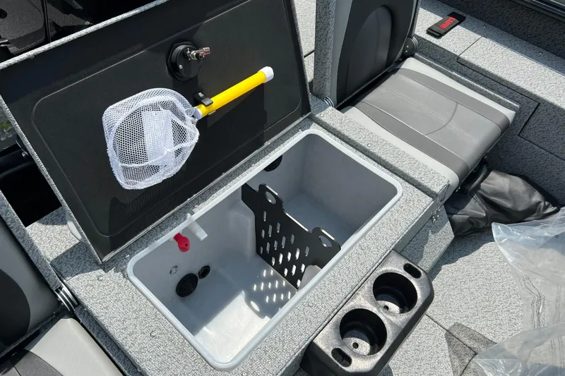 Slide: The Image of 2026 Lund 1875 Impact XS Sport boat interior with storage compartment and seating. - 10