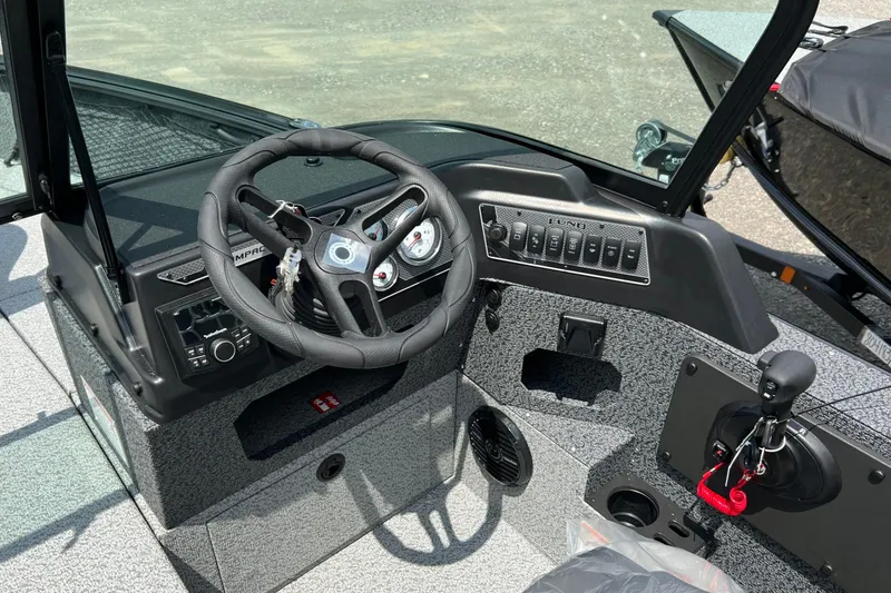 Slide: The Image of 2026 Lund 1875 Impact XS Sport boat dashboard with steering wheel and control panel. - 14