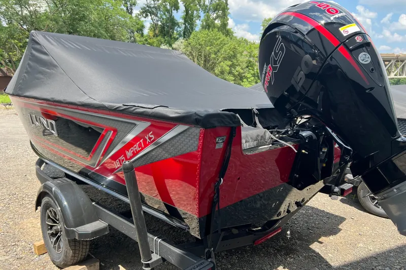 Slide: The Image of 2026 Lund 1875 Impact XS Sport boat with cover and powerful outboard motor. - 3