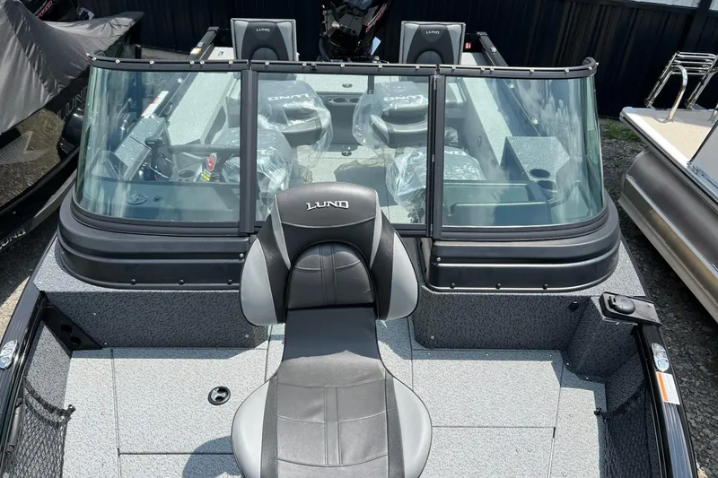 Slide: The Image of 2026 Lund 1875 Impact XS Sport boat with sleek design and spacious seating. - 4