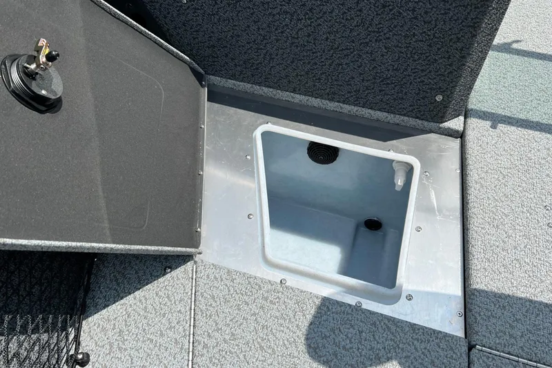 Slide: The Image of 2026 Lund 1875 Impact XS Sport boat storage compartment with open lid. - 8