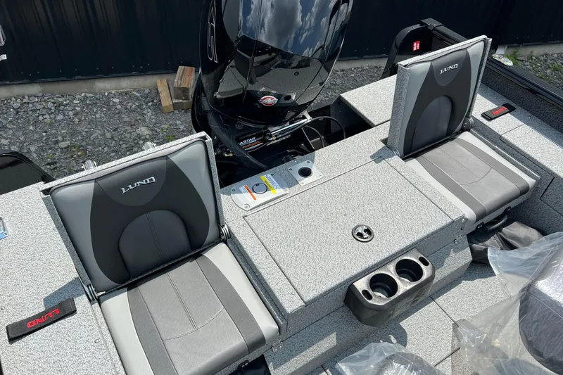 Slide: The Image of 2026 Lund 1875 Impact XS Sport boat interior with gray seating and storage compartments. - 9
